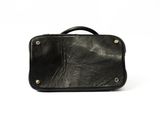 black leather suitcase on white background with clipping for the handle