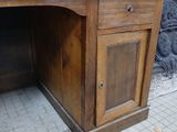 a wooden desk with a wooden chair on top of it