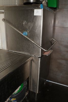 un réfrigérateur argenté qui se trouve dans une cuisine où il y a une poubelle