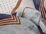 a close up of a blue and brown scarf with a polka dot design