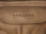 the back of a tan leather purse with a name on it