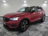 the red volvo suv is parked on a checkered tile floor