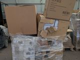 many boxes and packages stacked on a pallet in a warehouse