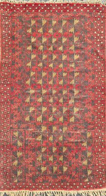 a red and black rug with a geometric design on it