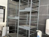 a kitchen with a sink, stove, and shelves in it