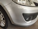 a close up of a car ' s front bumper and headlight