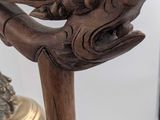 a statue of a hand holding a bell on a table