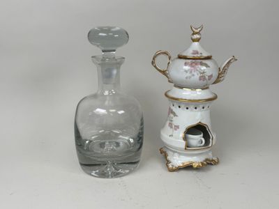 two vases and a bottle sitting on a table