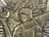 a close up of a metal sculpture of a man with a sword