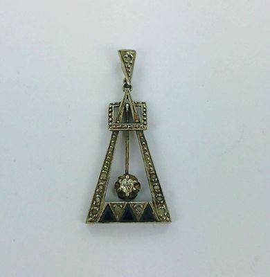 a silver pendant with a diamond and a lion on it