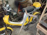a yellow scooter that is parked in a garage