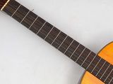 a close up of a guitar on a white surface