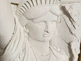 a statue of liberty on the wall of a building