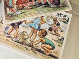 several children playing in the sand on a beach with a book open