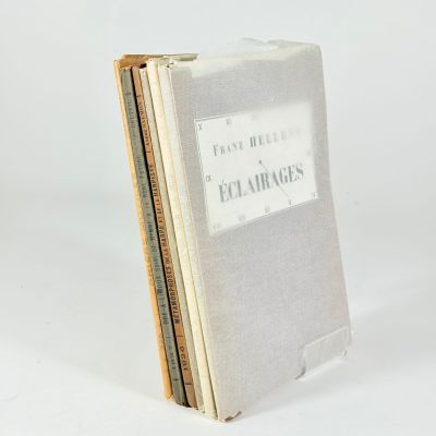 three books stacked on top of each other on a white surface
