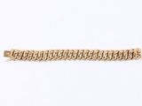a close up of a gold chain bracelet on a white background