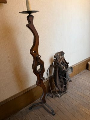 a candle that is on a stand in the corner of a room