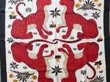 a red and black scarf with leopards and flowers on it