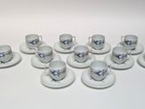 a lot of cups and saucers sitting on a table