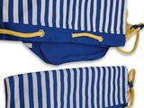 pair of blue and white striped umbrellas with yellow handles