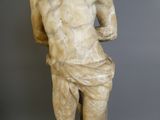 marble statue of a man holding a vase in his right hand