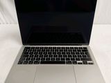 a silver laptop computer sitting on a white surface