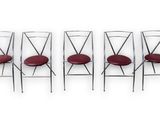 a set of four chrome steel chairs with red leather seats