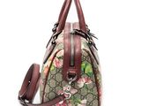 a close up of a handbag with flowers on it