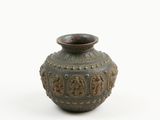 a brown vase with a design on it on a white surface