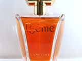 a close up of a bottle of perfume on a white surface