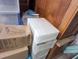 a stack of boxes sitting on the floor next to a trash can