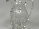a glass pitcher that is sitting on a table