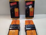 two yellow and black cell phones sitting on top of a white table