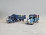 two toy trucks sitting next to each other on a table