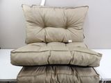 two pillows on top of each other on a white table