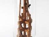 a glass jar with a wooden structure inside of it