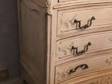 a white chest of drawers with a mirror on top of it