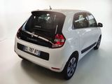 a picture of a small white car parked in a garage