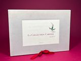 a white box with a red ribbon and a picture of a bird on it