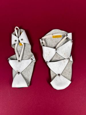 pair of origami sandals on a red background