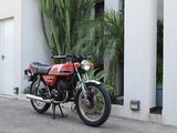 a red motorcycle parked in front of a white building