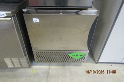two stainless steel refrigerators sitting next to each other in a room