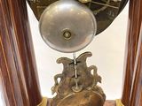 a clock that is sitting on top of a wooden stand