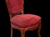 an image of a chair with a red upholstered seat on a black background