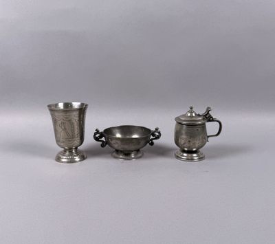 three pieces of silverware are sitting on a white surface
