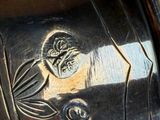 a close up of a vase with a design on it