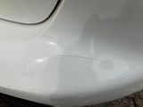 a close up of a car ' s bumper with scratches on it