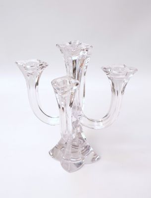 un bougeoir en verre contenant trois bougies