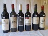 several bottles of wine are lined up on a table