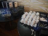 a table with a bunch of cups and a tray of silverware